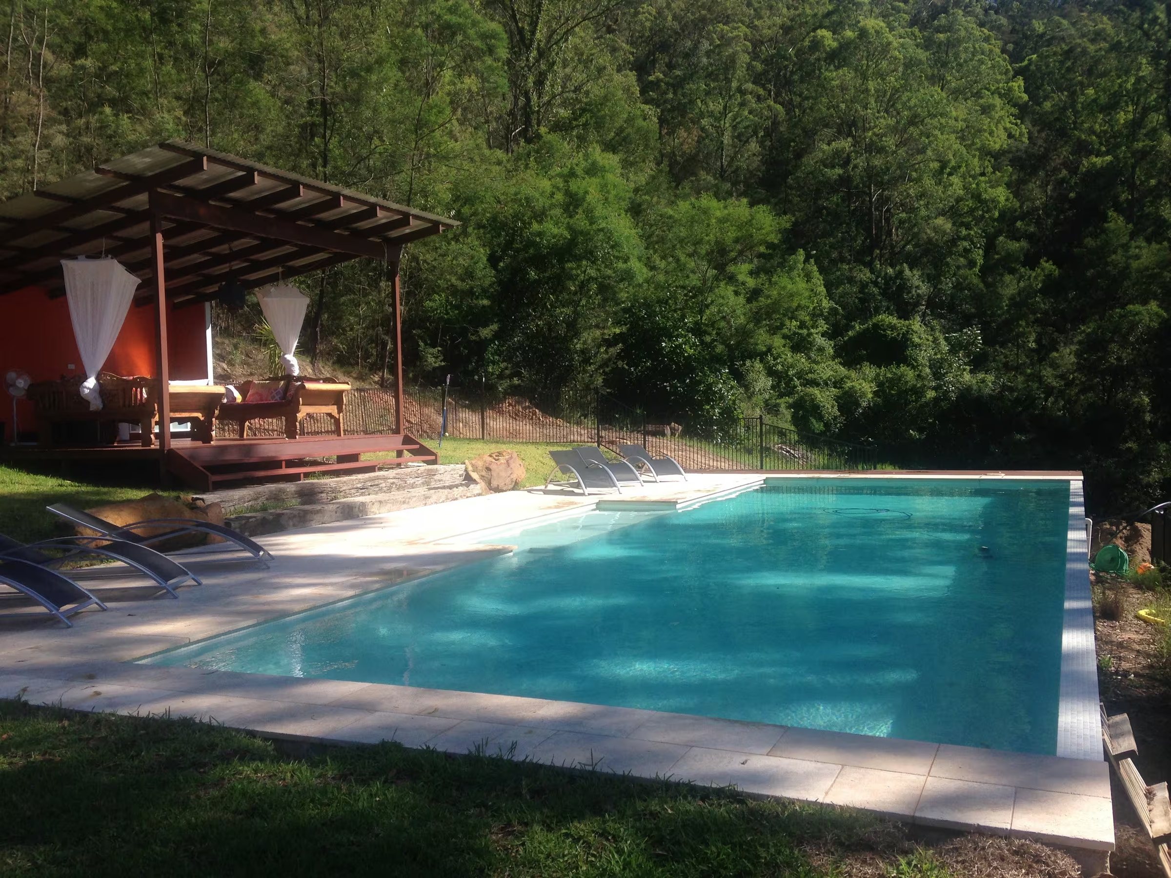Pool surrounded by bush at the retreat property