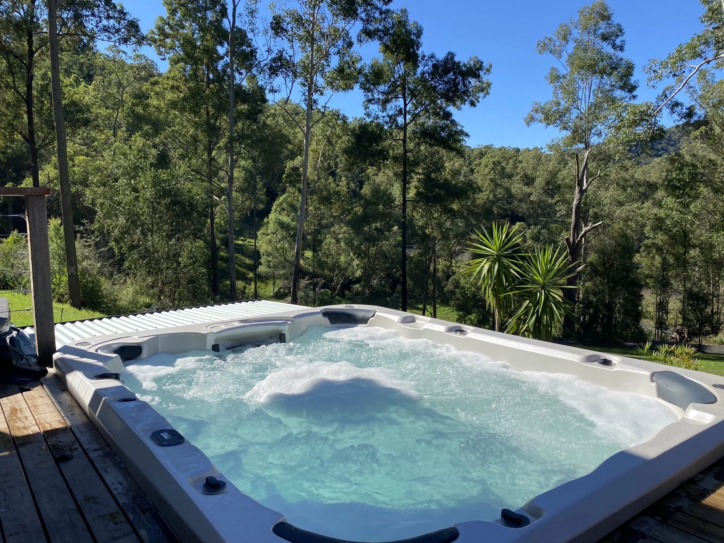 Outdoor hydrotherapy spa with bush views